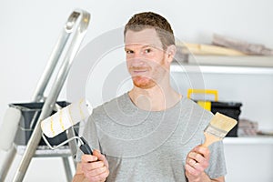 Man holding paint roller