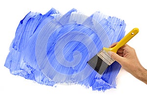 Man holding paintbrush painting blue wall, home decorating, white background, copy space