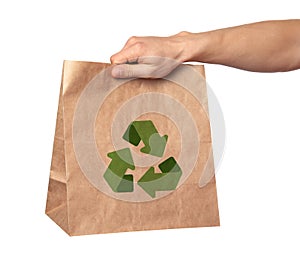 Man holding paper bag with recycling symbol on white background, closeup