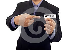 Man Holding Paper With Get Rich Text