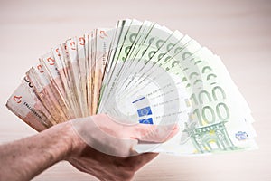 Man holding paper money - euros in the hand