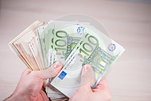 Man holding paper money - euros in the hand