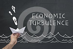 Economic turbulence concept on chalkboard