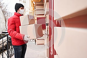 Man holding parcel box while standing near the door entrance