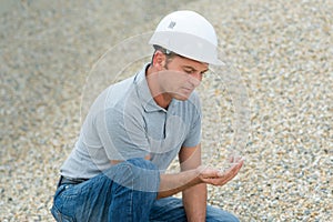 man holding pebles in hand