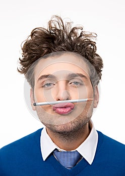 Man holding a pencil between the lips and nose