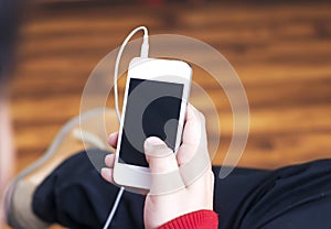 Man holding a phone in hand, Listening to music.