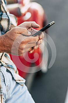 Man holding phone in hands texting message or using mobile apps, checking social media applications on new black smartphone,