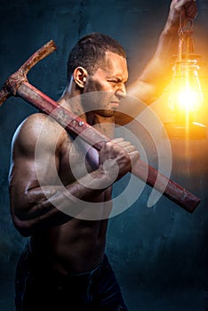 Man holding pickaxe and oil lamp photo