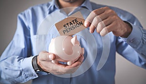 Man holding piggy bank. State Pension