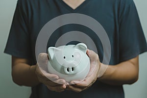 Man holding a piggy bank white on hand.Saving money business investment finance