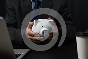 man holding a piggy bank white on hand.Saving money business investment finance