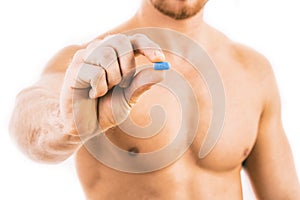 Man holding a pill used for Pre-Exposure Prophylaxis