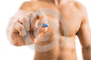 Man holding a pill used for Pre-Exposure Prophylaxis PrEP
