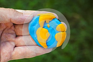 Man holding planet Earth in his hand