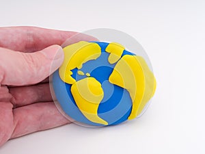 A man holding the planet Earth in his hand
