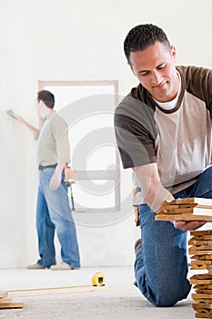 A man holding planks of wood