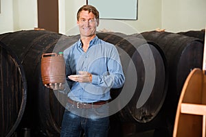 Man holding plastic bottle with liquor