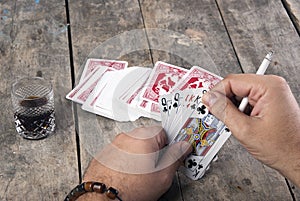 Man holding A Poker Hand Full House