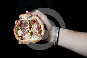 Man holding a pommegranate