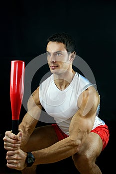 Man holding a power club on black background