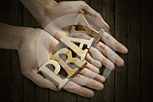 Man holding pray word in palm photo