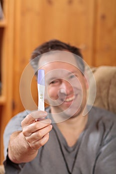 Man holding a pregnancy test