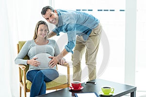 Man holding pregnant womans stomach