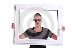 Man holding a pvc window frame photo
