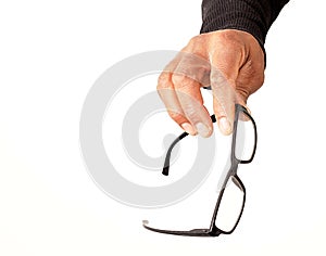 Man holding reading glasses in an optician shop