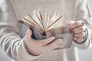 Man holding reading open book or holy bible