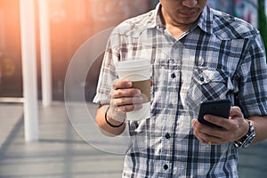 The man holding the recyclable coffee cup and make thumb up