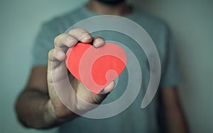 Man holding red heart.