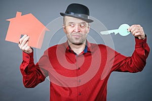 Man holding red house model