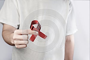 Man holding red ribbon Hiv Aids