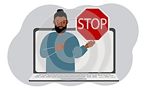 A man holding a red stop sign in a laptop screen. Virus, attack, error, account or page deletion.