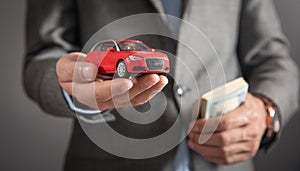 Man holding red toy car