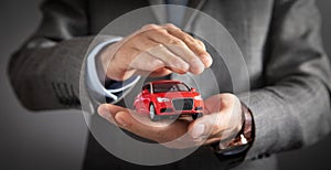 Man holding red toy car