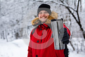 Man holding refillable mug selective focus