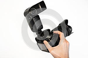 Man holding reflex camera with on-camera flash on white background top view