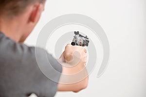 Man holding a revolver in hands ready to shoot.