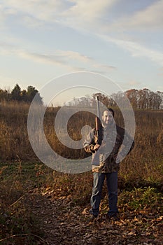 Man holding rifle in fields