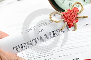 Man holding a rolled up scroll of last will and testament fastened with natural brown jute twine hemp rope.