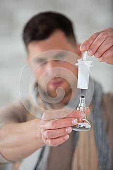 man holding screw in bulb and holder