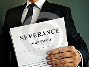Manager is holding Severance Agreement papers photo