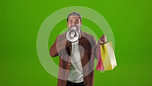 Man holding shopping bags and shouting in loudspeaker