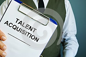 Man is holding sign talent acquisition strategy