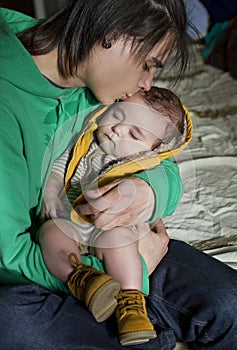 Man holding a sleeping baby in his arms