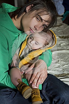 Man holding a sleeping baby in his arms