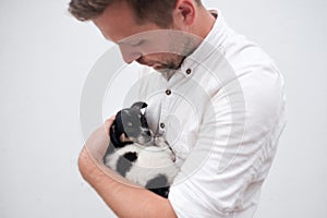 Man holding a small puppy in his hands